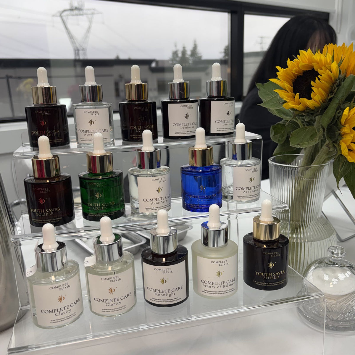 Tiered serum display with sunflowers at Creator's Lab