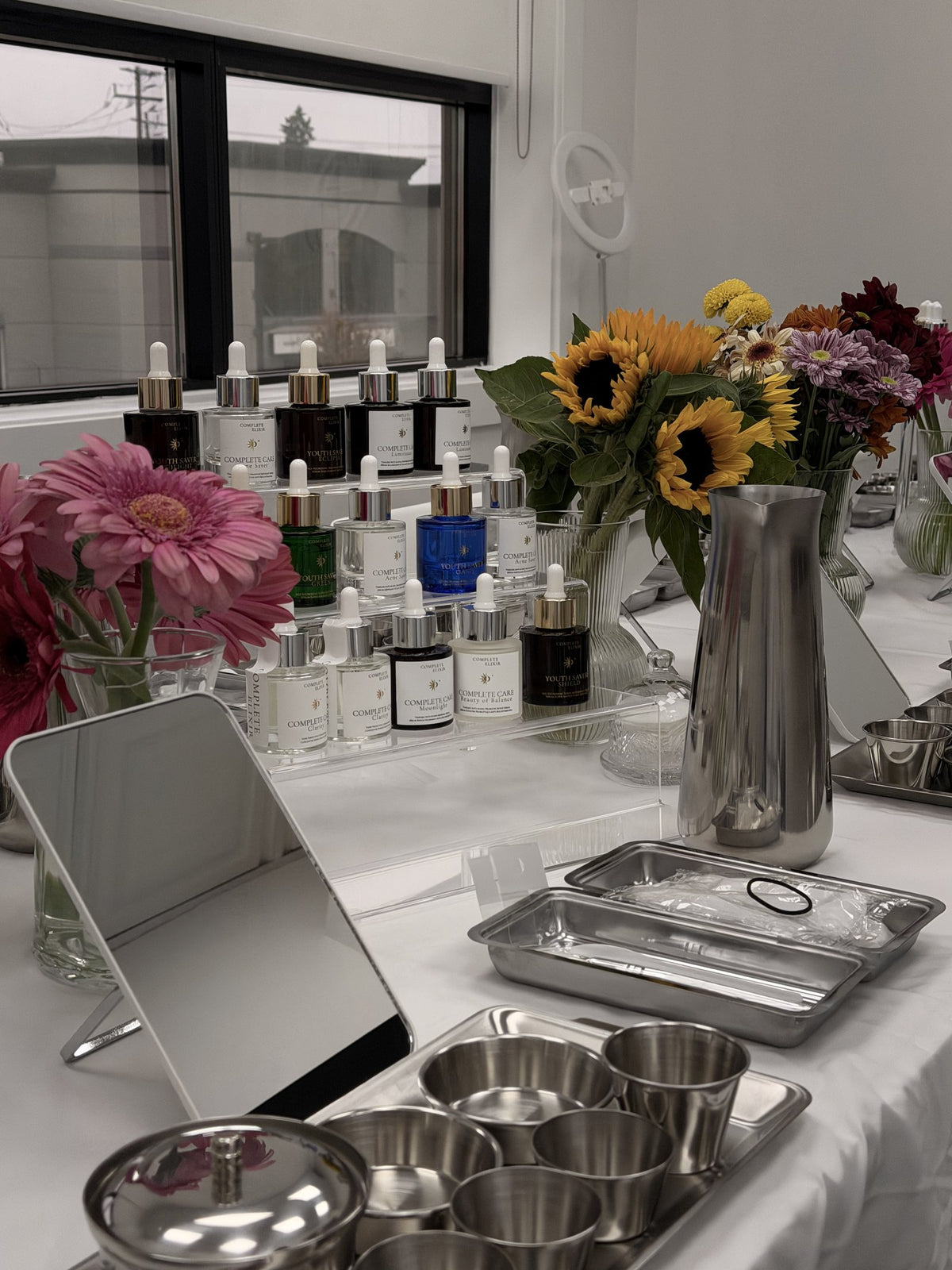 A prepared Creator's Lab table with products, mirrors and tools for each guest