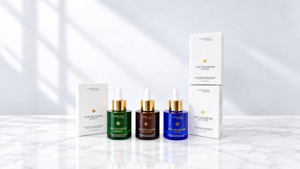The Complete Elixir Youth Saver serums, Green, Eclipse and Oasis, with their cartons on marble in daylight